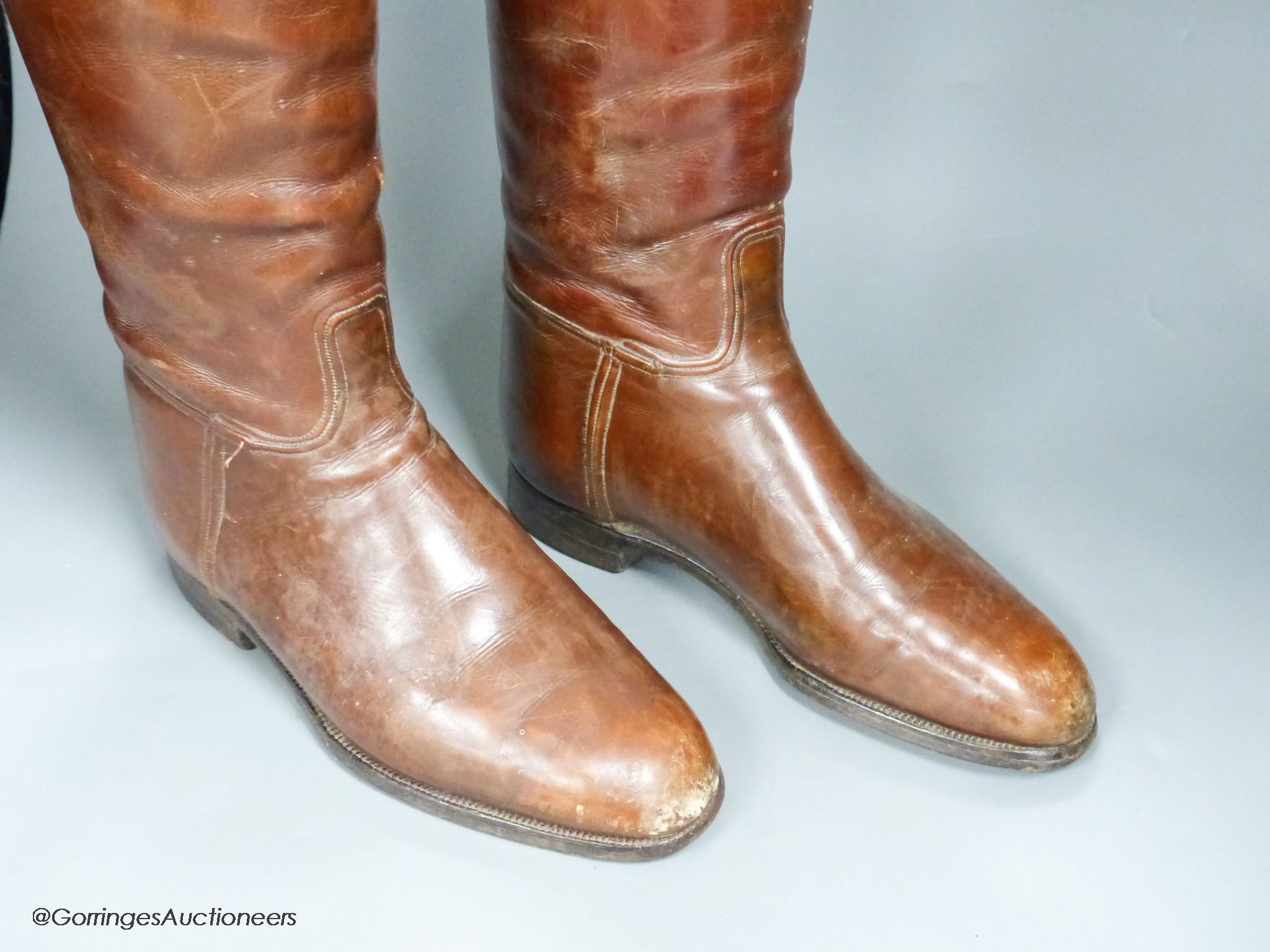 A pair of brown leather riding boots and trees